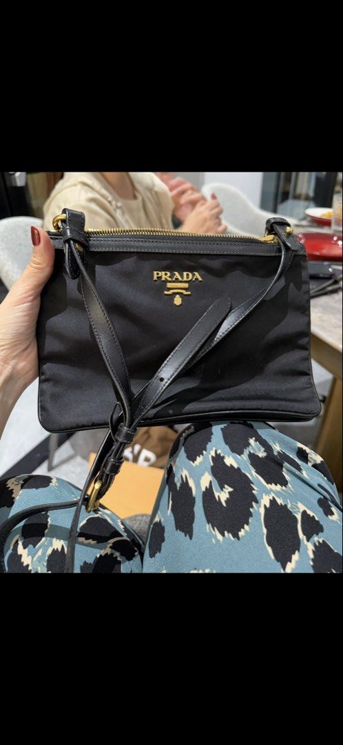 Prada Black Nylon Crossbody Bag (Category: Luxury Bags & Wallets) located in Manila. Submitted by kimbokjoo97 (Listing ID 1453473605, Image 1). Description: - Authentic Prada crossbody bag - dust bag included - Color: Black - Material: Nylon - Hardware: Gold-tone - Closure: Zipper - Strap: Adjustable leather - Dimensions: Approx. 9" W x 6" H - Features: Lightweight, practical for everyday use, ideal for essentials.