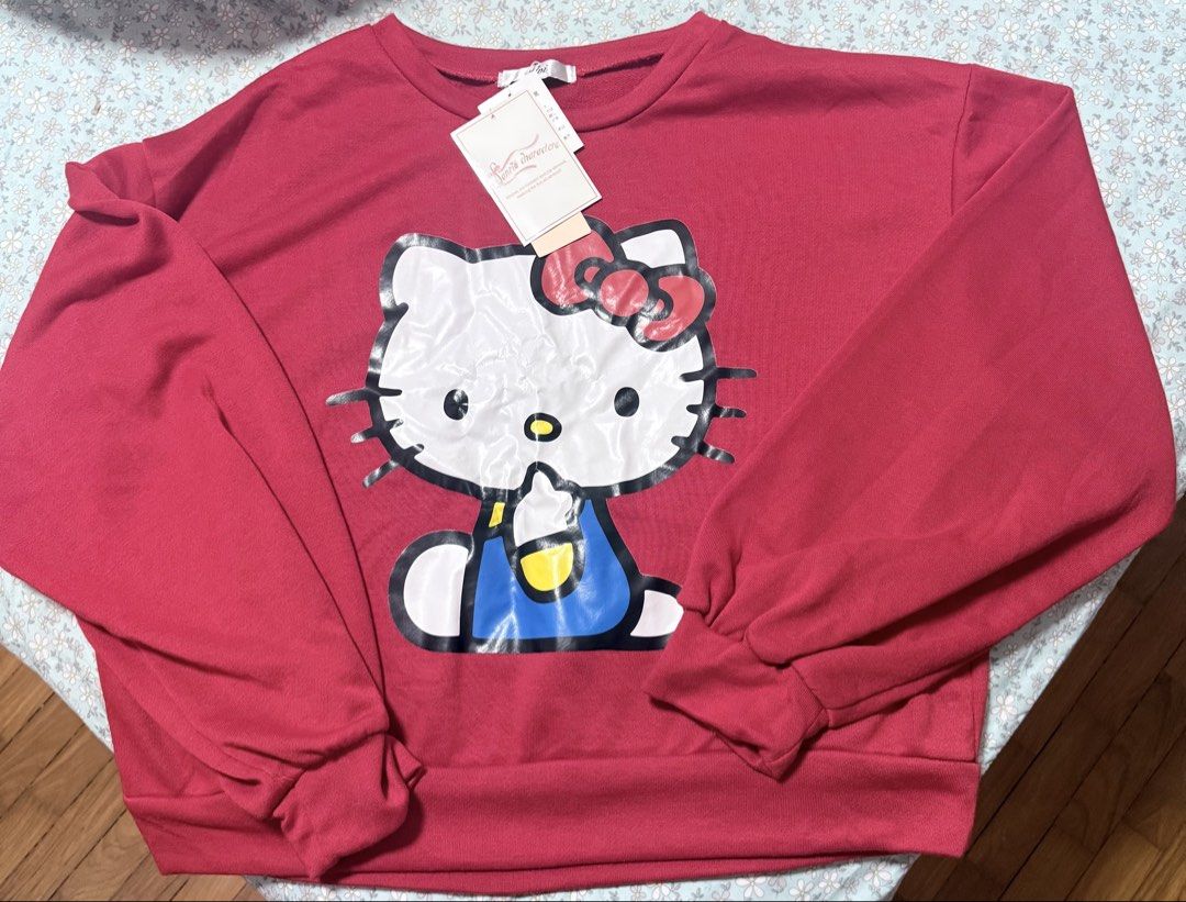 Pull over (Category: Other Tops) located in Singapore. Submitted by sssss (Listing ID 1453606763, Image 1). Description: - Adorable red pull-over top - Features a charming Kitty graphic - Comfortable and stylish design - Perfect for casual wear - Adds a fun pop of color to your wardrobe.