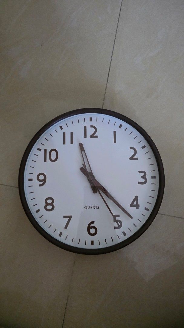Quartz Wall Clock - Brown Frame (Category: Clocks) located in Kuala Lumpur. Submitted by crychan (Listing ID 1453440708, Image 1). Description: - 10 inch diameter - Simple brown framed quartz wall clock - Easy to read numbers and hands - Perfect for any room in the house or office - Battery operated - Ready to hang.
