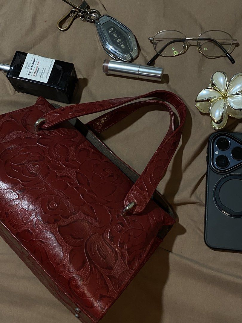 Red Embossed Leather Handbag with Floral Design (Category: Luxury Bags & Wallets) located in Manila. Submitted by cdb_22 (Listing ID 1453614190, Image 2). Description: - Stunning red leather handbag - Intricate floral embossed pattern all over - Comfortable, good-length handles for carrying - Structured design, ideal for everyday use - Ample interior space for essentials - A versatile, classic piece that complements many outfits.