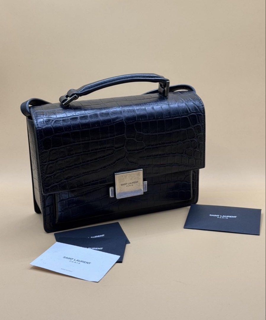 Saint Laurent Black Croc Embossed Leather Shoulder Bag (Category: Luxury Bags & Wallets) located in Quezon City. Submitted by mitchy09 (Listing ID 1453440011, Image 1). Description: - Authentic Black Saint Laurent Shoulder Bag - Luxurious Croc Embossed Leather - Elegant Silver-Tone Clasp with 'Saint Laurent Paris' Engraving - Comes with Original Dust Bag and Authenticity Cards - Versatile Design: Ideal for Day or Night Use.