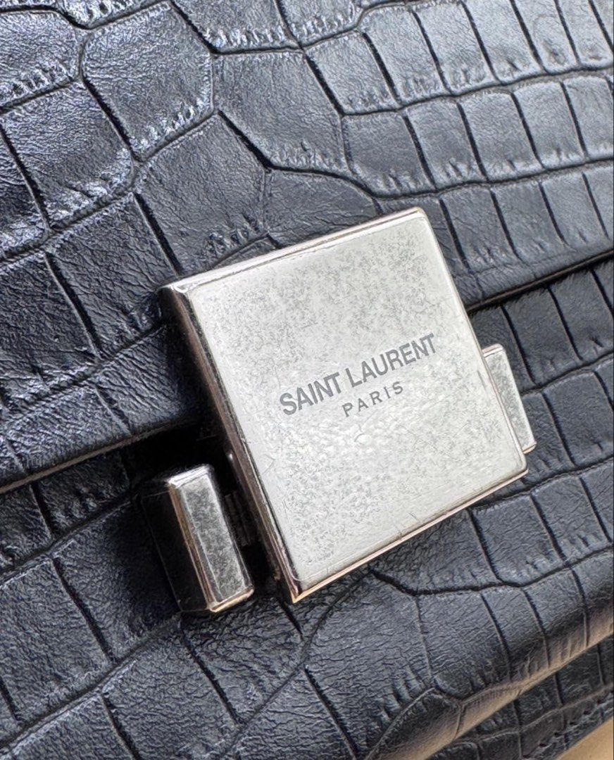 Saint Laurent Black Croc Embossed Leather Shoulder Bag (Category: Luxury Bags & Wallets) located in Quezon City. Submitted by mitchy09 (Listing ID 1453440011, Image 2). Description: - Authentic Black Saint Laurent Shoulder Bag - Luxurious Croc Embossed Leather - Elegant Silver-Tone Clasp with 'Saint Laurent Paris' Engraving - Comes with Original Dust Bag and Authenticity Cards - Versatile Design: Ideal for Day or Night Use.