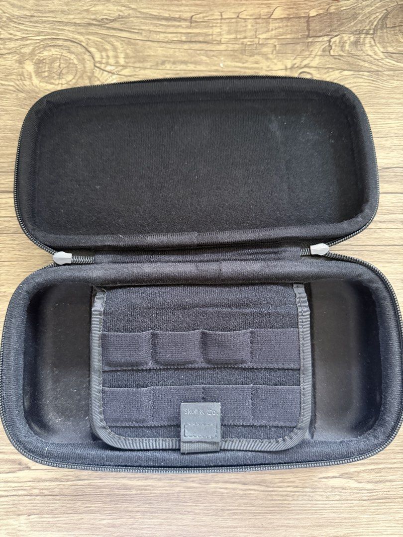 Skull & Co. Nintendo Switch Carrying Case (Category: Cases & Covers) located in Muntinlupa City. Submitted by theanicaela (Listing ID 1453618335, Image 2). Description: - Black carrying case for Nintendo Switch - Built-in handle for easy portability - Interior mesh pocket for accessories - Dedicated slots for game cartridges - Protects your console during travel.