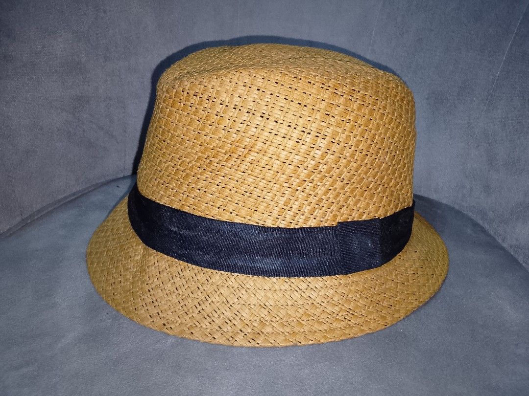 Straw Fedora Hat with Black Band (Category: Hats & Beanies) located in Binangonan. Submitted by yuristalin888 (Listing ID 1453562837, Image 2). Description: - Classic straw fedora hat - Woven texture all over - Features a dark blue band around the crown - Ideal for sunny days - Versatile style for casual or dressy outfits.
