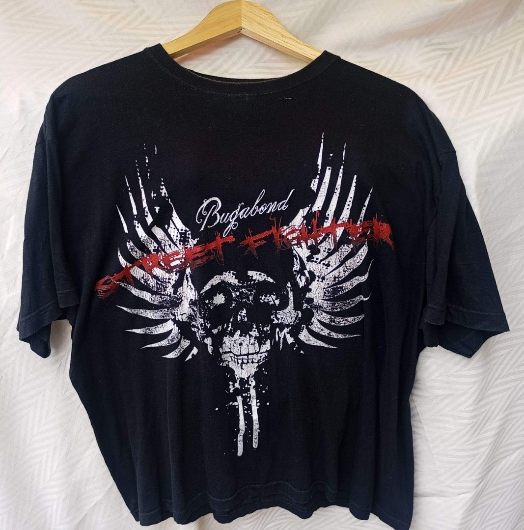 Street Fighter Winged Skull Graphic Tee (Category: Tshirts & Polo Shirts ) located in Davao. Submitted by karaangbisti (Listing ID 1453538907, Image 1). Description: Street Fighter Winged Skull Graphic Tee Size: XL on tag Width: 23 inches Length: 27 inches Color rate: 9.8/10 Good condition Issue: faded back( discoloration).