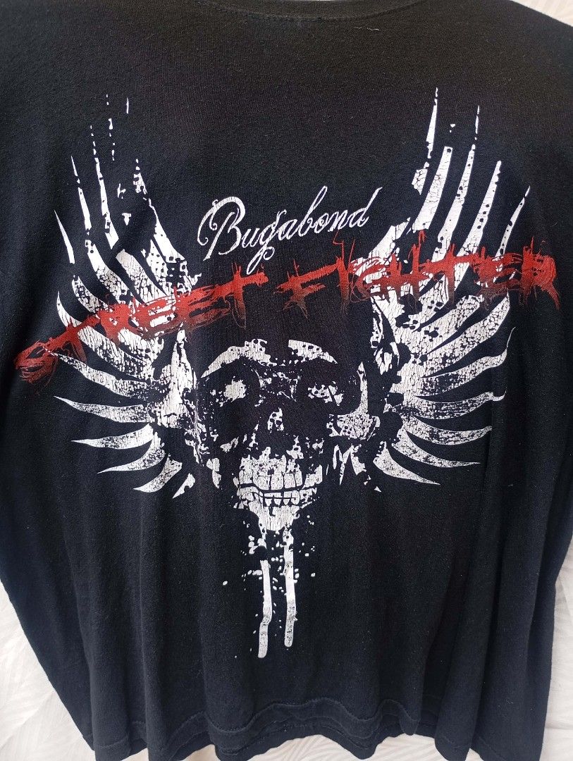 Street Fighter Winged Skull Graphic Tee (Category: Tshirts & Polo Shirts ) located in Davao. Submitted by karaangbisti (Listing ID 1453538907, Image 2). Description: Street Fighter Winged Skull Graphic Tee Size: XL on tag Width: 23 inches Length: 27 inches Color rate: 9.8/10 Good condition Issue: faded back( discoloration).