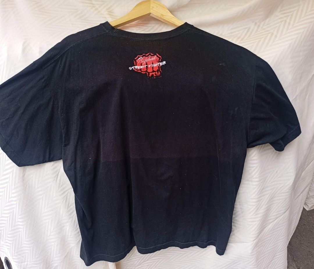Street Fighter Winged Skull Graphic Tee (Category: Tshirts & Polo Shirts ) located in Davao. Submitted by karaangbisti (Listing ID 1453538907, Image 3). Description: Street Fighter Winged Skull Graphic Tee Size: XL on tag Width: 23 inches Length: 27 inches Color rate: 9.8/10 Good condition Issue: faded back( discoloration).