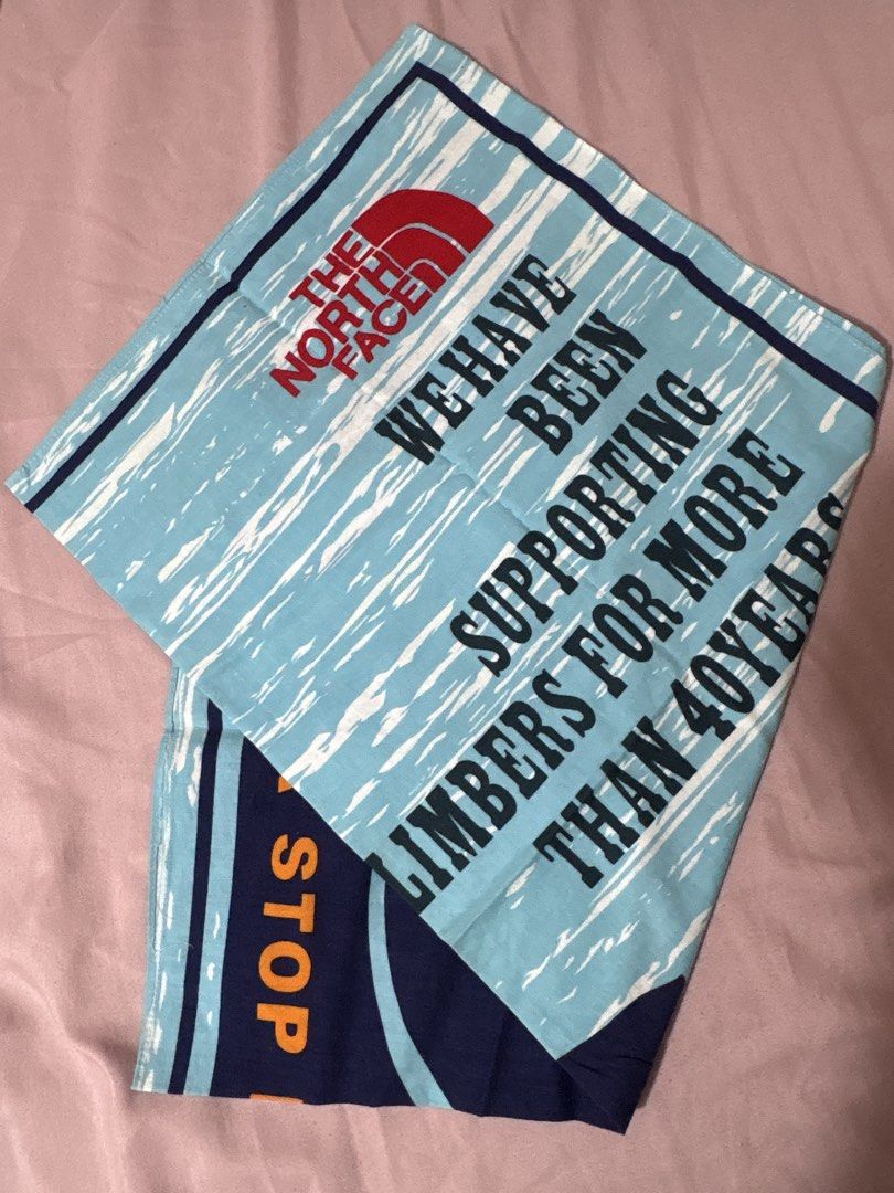 The North Face Bandana - Supporting Climbers (Category: Activewear) located in Cavite. Submitted by miknad (Listing ID 1453434470, Image 1). Description: - Brand: The North Face - Color: Light Blue - Design: Features text 'We have been supporting climbers for more than 40 years' and 'STOP' on the corner. - Size: Approximately 20x20 inches - Perfect for: Outdoor adventures or as a unique statement piece. Used once. Pls pm if interested. Ty!.