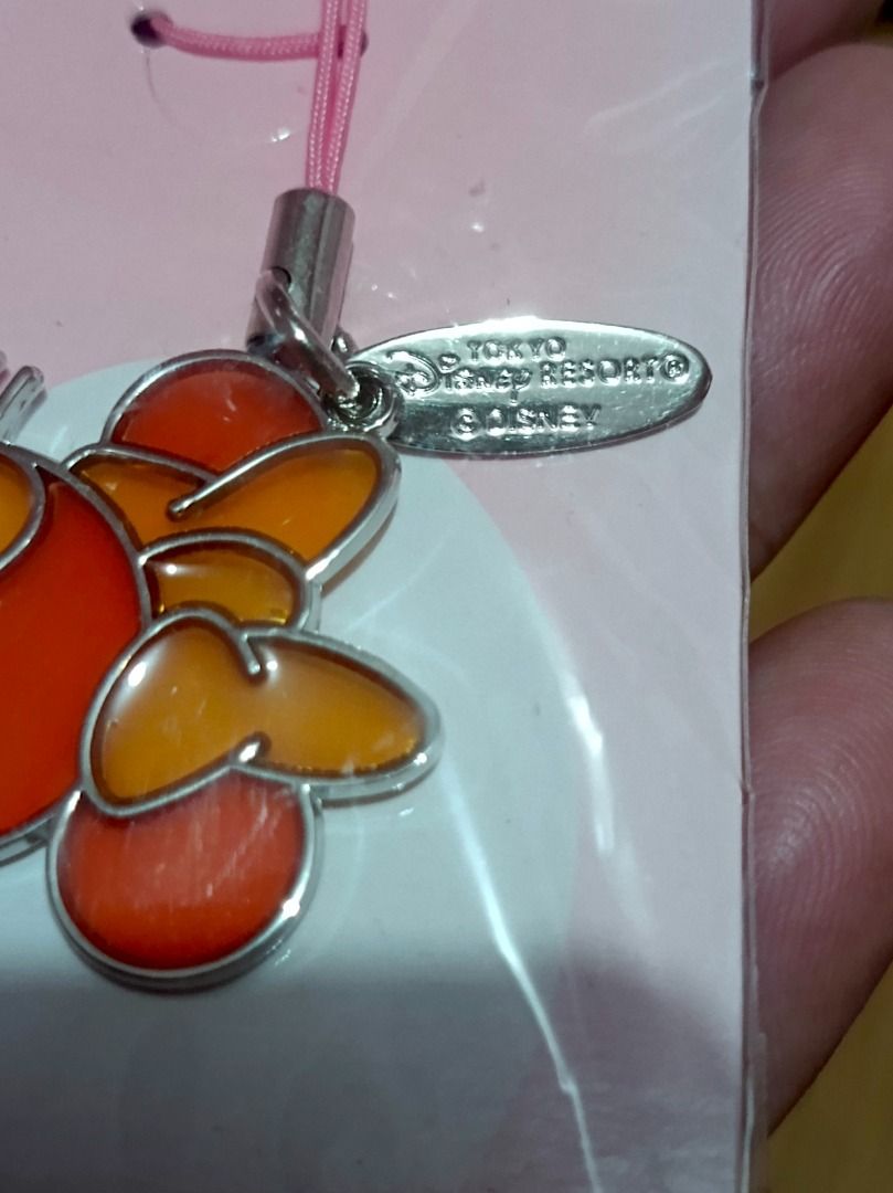 Tokyo Disney Resort Minnie Mouse Charm (Category: Charms) located in Makati City. Submitted by nyxhemera26 (Listing ID 1453616143, Image 3). Description: Tokyo Disney Resort Minnie Mouse Charm - Authentic Tokyo Disney Resort Minnie Mouse charm - Features vibrant orange and red enamel details - Comes with a cute pink strap - Includes a metal tag for authenticity - Perfect accessory for your phone or bag.