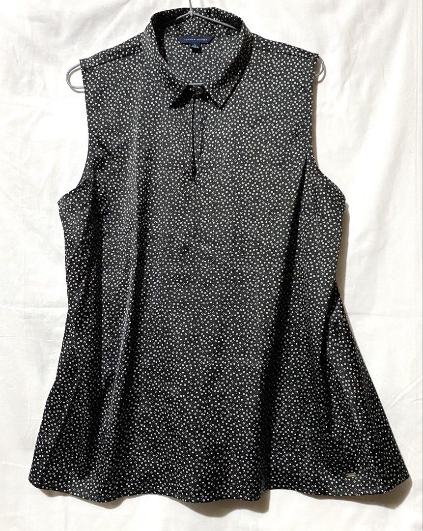 Tommy Hilfiger Sleeveless Blouse - Black with White Polka Dot Pattern (Category: Sleeveless) located in Baguio. Submitted by royalriver17 (Listing ID 1453441539, Image 1). Description: Sleeveless collared blouse by Tommy Hilfiger. Black with white polka dots. Button closure at neck. Small metal logo tag on hem. Perfect for smart casual..