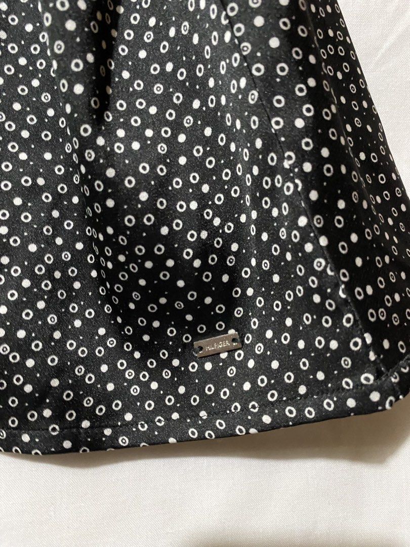 Tommy Hilfiger Sleeveless Blouse - Black with White Polka Dot Pattern (Category: Sleeveless) located in Baguio. Submitted by royalriver17 (Listing ID 1453441539, Image 3). Description: Sleeveless collared blouse by Tommy Hilfiger. Black with white polka dots. Button closure at neck. Small metal logo tag on hem. Perfect for smart casual..