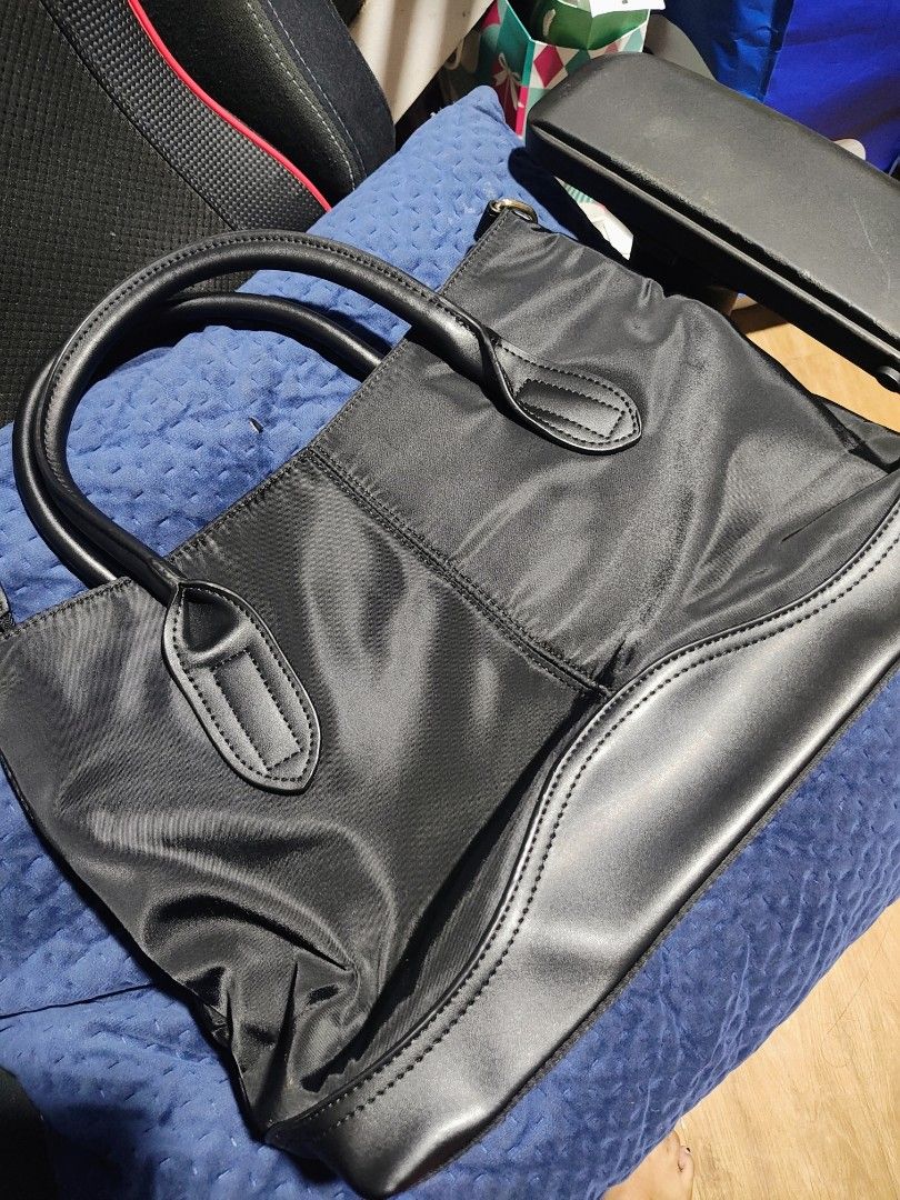 Tory Burch Black Nylon Leather Tote Bag (Category: Luxury Bags & Wallets) located in Taytay. Submitted by jhovie0202 (Listing ID 1453576276, Image 2). Description: - Classic black Tory Burch tote bag - Durable nylon with leather trim - Features iconic Tory Burch logo - Spacious interior for essentials - Secure zipper closure - Ideal for everyday use or travel.