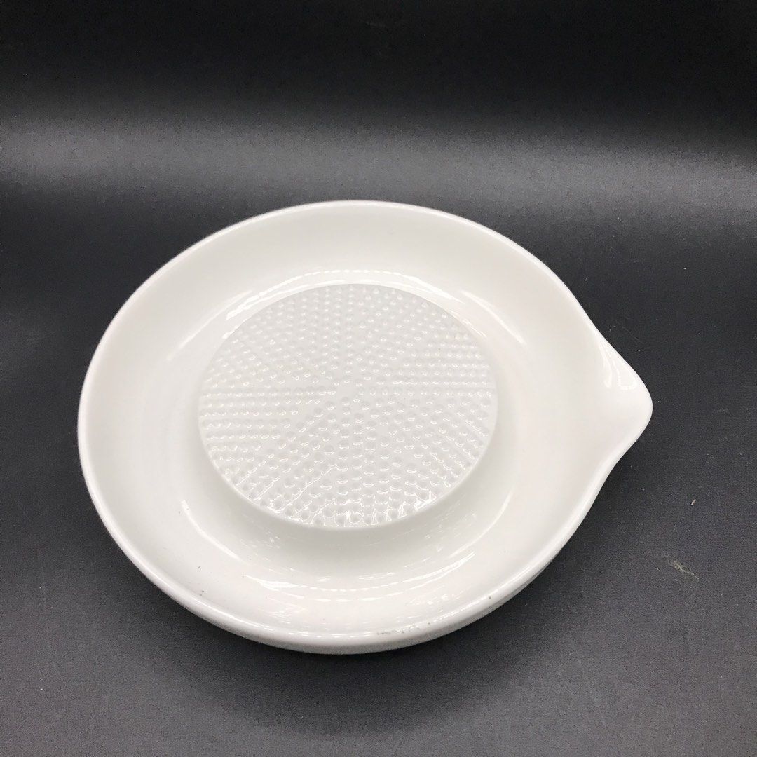 White Ceramic Grater Bowl with Spout (Category: Other Kitchenware & Tableware) located in Baao. Submitted by all.things.japan (Listing ID 1453541813, Image 2). Description: Brand New with Box 6.5 (d) x 1.25 inches - White ceramic grater bowl - Textured center for easy grating - Ideal for ginger, garlic, and wasabi - Built-in spout for convenient pouring - Dishwasher safe for easy cleaning - Simple and functional kitchen essential.