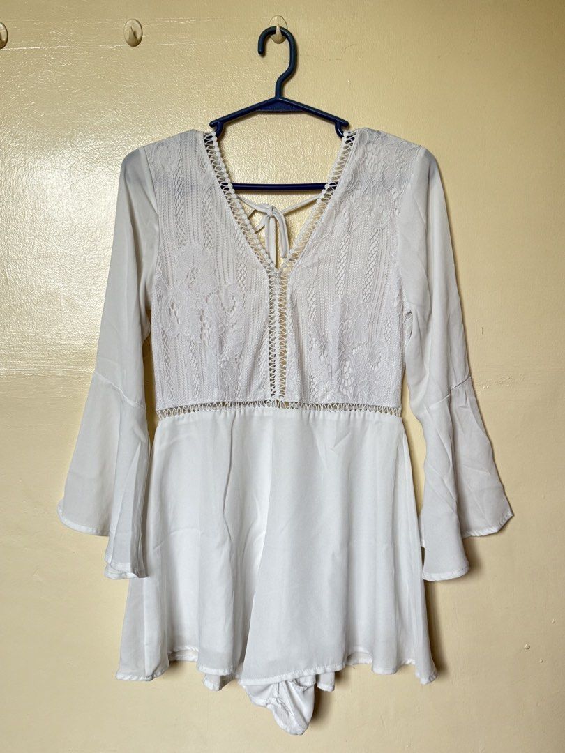 White Lace Trim Bell Sleeve Romper (Category: Rompers) located in Muntinlupa City. Submitted by so_me_reyna (Listing ID 1453542546, Image 1). Description: - Can fit Small to Medium - Chic white romper with delicate lace detailing on the bodice. - Features stylish bell sleeves for a bohemian touch. - Convenient tie-back closure at the neck for a customizable fit. - Made from lightweight and flowy fabric, ensuring comfort and ease of movement. - Id