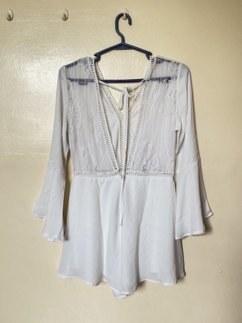 White Lace Trim Bell Sleeve Romper (Category: Rompers) located in Muntinlupa City. Submitted by so_me_reyna (Listing ID 1453542546, Image 2). Description: - Can fit Small to Medium - Chic white romper with delicate lace detailing on the bodice. - Features stylish bell sleeves for a bohemian touch. - Convenient tie-back closure at the neck for a customizable fit. - Made from lightweight and flowy fabric, ensuring comfort and ease of movement. - Id