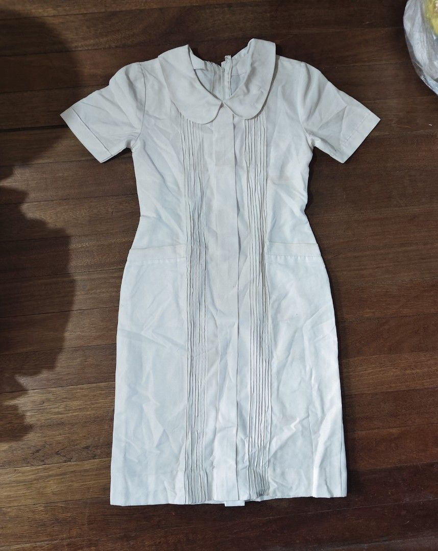 white nursing uniform dress (Category: Medical Supplies & Tools) located in Bulacan. Submitted by angel.decluttersx (Listing ID 1453461676, Image 3). Description: ww provided fits to small-medium size W 32" waistline L 39" no issue zipper is working! with two pockets no issue.