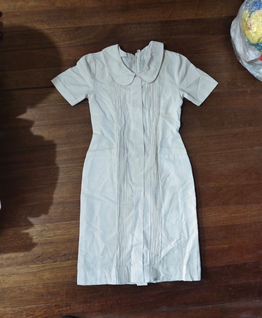 white nursing uniform dress (Category: Medical Supplies & Tools) located in Bulacan. Submitted by angel.decluttersx (Listing ID 1453461676, Image 2). Description: ww provided fits to small-medium size W 32" waistline L 39" no issue zipper is working! with two pockets no issue.