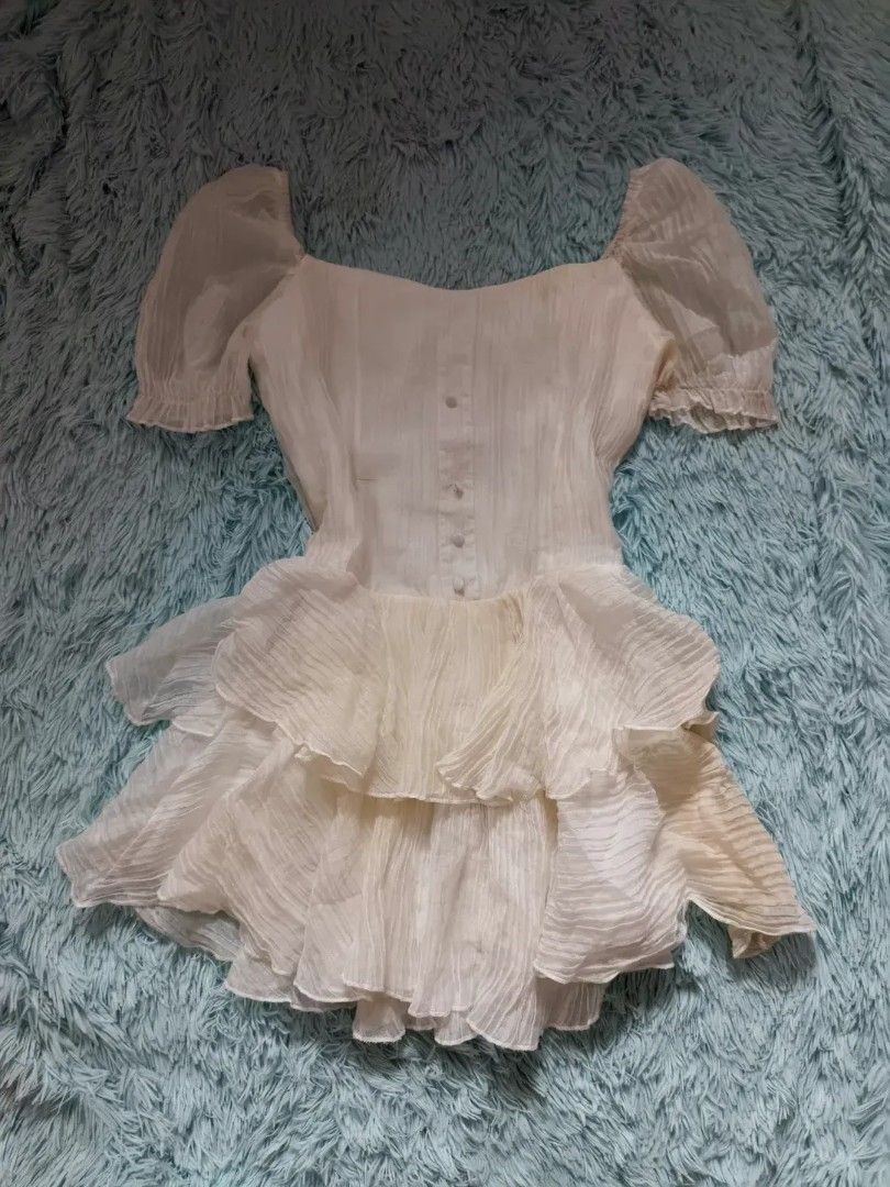 White Puff Sleeve Tiered Ruffle Dress (Category: Dresses) located in Quezon City. Submitted by alluring.avenue (Listing ID 1453482088, Image 1). Description: - Adorable white dress with charming puff sleeves. - Features a flattering square neckline and functional button details down the front. - Flowy skirt with stylish tiered ruffles. - Versatile for parties or everyday casual outings. - Effortless to style for any occasion..