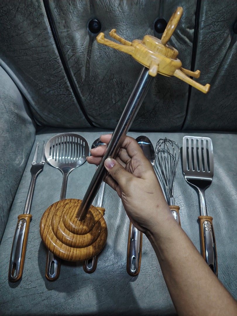 Wooden Handle Kitchen Utensil Set with Stand (Category: Other Kitchenware & Tableware) located in Manila. Submitted by nixwear_it (Listing ID 1453590293, Image 2). Description: - Complete set of kitchen tools with a stylish wooden and chrome finish. - Includes: whisk, ladle, slotted spoon, slotted turner, and carving fork. - All tools hang neatly on the included wooden stand. - Ideal for everyday cooking and baking tasks. - Enhances the look of y