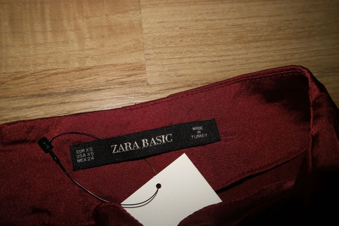ZARA BASIC Burgundy Satin Midi Skirt XS (Category: Skirts) located in Caloocan City. Submitted by isha_jane26 (Listing ID 1453542318, Image 2). Description: - Burgundy ZARA BASIC midi skirt - High-waisted design - Ruched detail at the side - Front slit for added style - Estimated size XS - Perfect for dressing up or down.