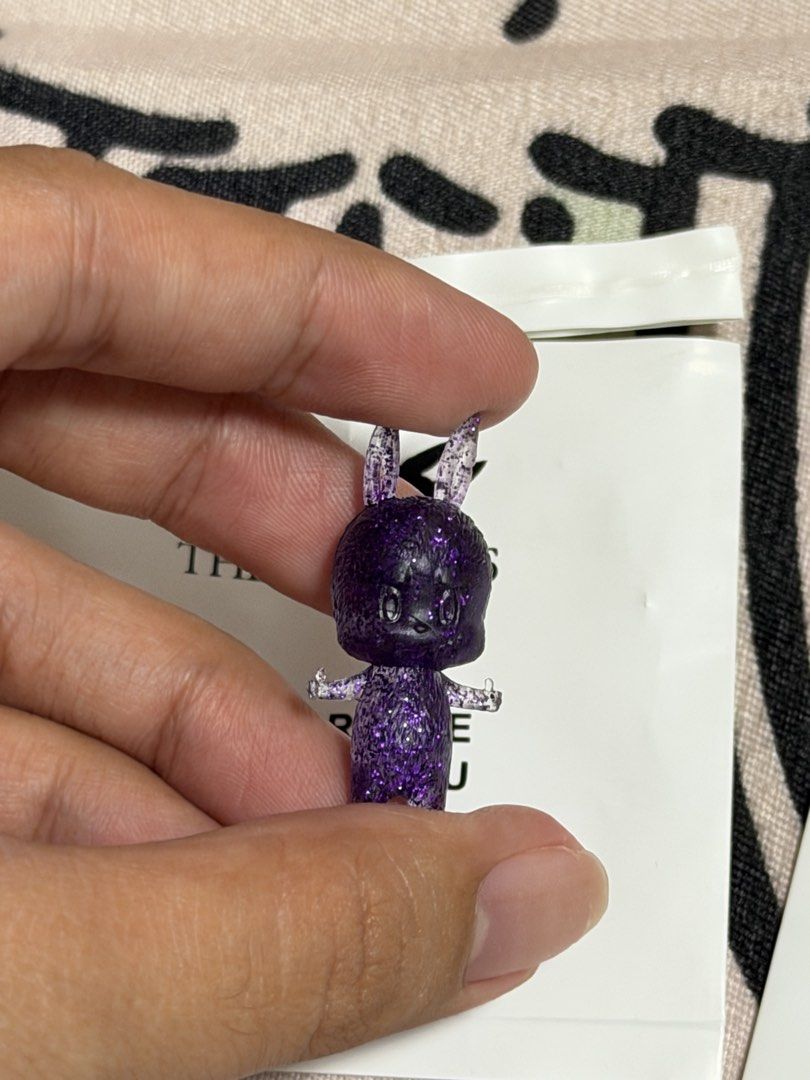 Zimomo Pop Bean (OG Design) (Category: Designer & Blind Box Toys) located in Manila. Submitted by jnndeclutter (Listing ID 1453581322, Image 1). Description: Zimomo Pop Bean Purple Glitter 2011 Manuf defect scratch on face.