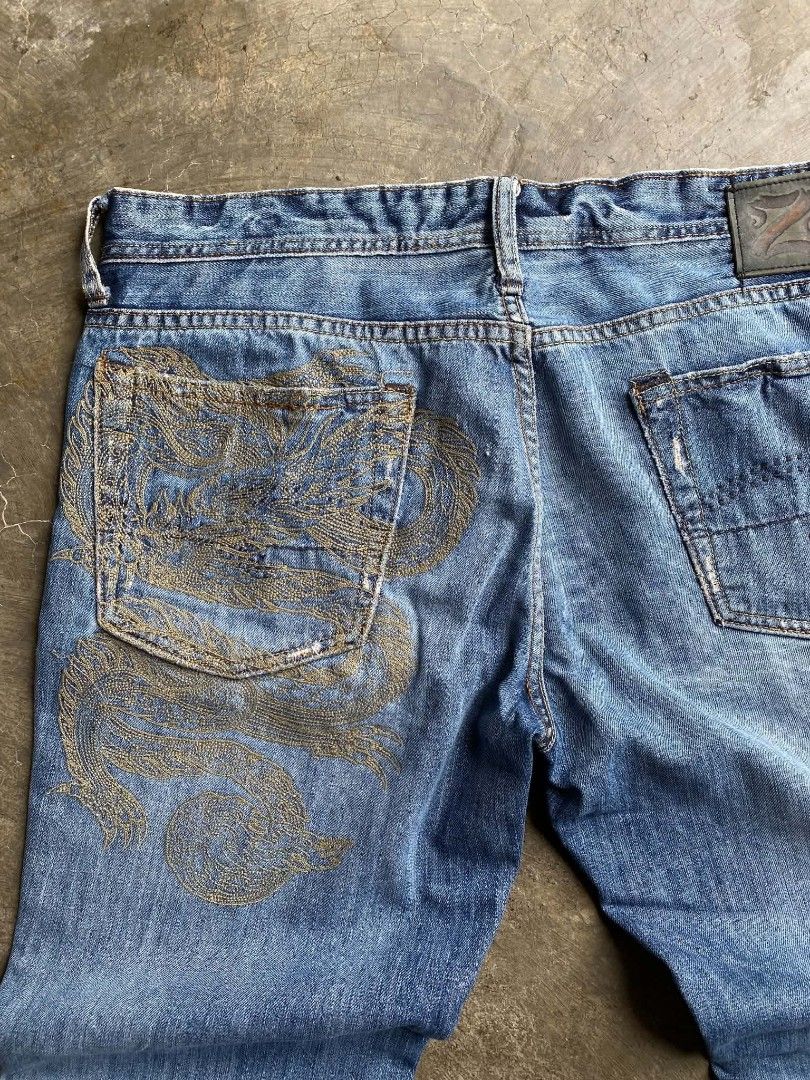 Z.U.M. Jeans with Dragon Embroidery (Category: Jeans) located in Cabanatuan. Submitted by vivian_nicole_03 (Listing ID 1453537412, Image 1). Description: - Blue denim jeans - Unique dragon embroidery on back pocket - Distressed details on pockets and hem - Button and zip fly closure - Classic five-pocket design - Ideal for a stylish casual outfit.