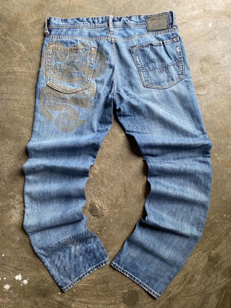 Z.U.M. Jeans with Dragon Embroidery (Category: Jeans) located in Cabanatuan. Submitted by vivian_nicole_03 (Listing ID 1453537412, Image 2). Description: - Blue denim jeans - Unique dragon embroidery on back pocket - Distressed details on pockets and hem - Button and zip fly closure - Classic five-pocket design - Ideal for a stylish casual outfit.