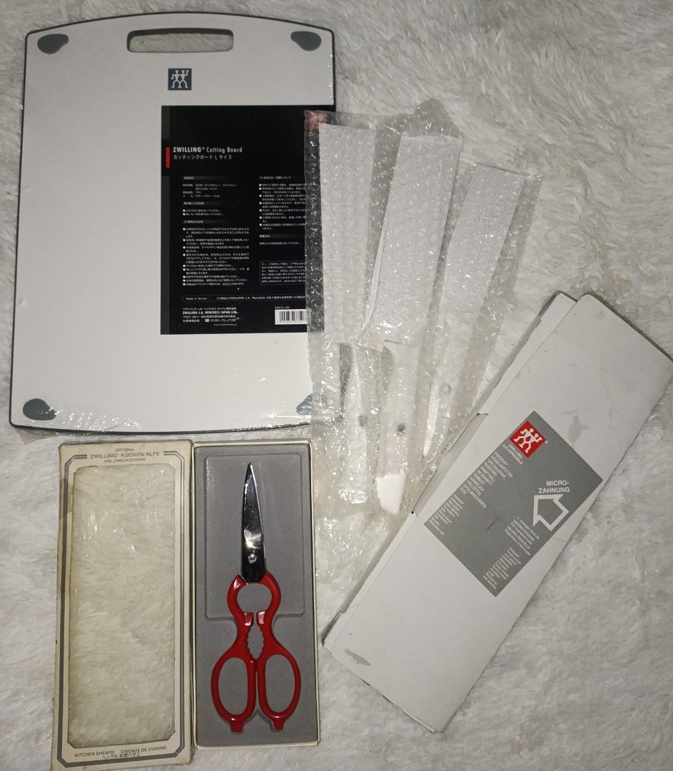 Zwilling J.A. Henckels Set (Category: Cookware & Accessories) located in Bacoor. Submitted by MommahAnnaOnlineShop (Listing ID 1453613917, Image 1). Description: - Genuine Zwilling J.A. Henckels kitchen set. - Includes a large cutting board. - Features a pair of red-handled kitchen shears. - Comes with additional knives (still in packaging). - Known for high quality and durability. - Zwilling J.A. Henckels Set Modern Cutting Board and Knife -Vint