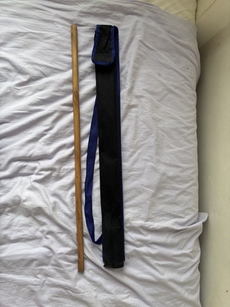 1pc Arnis Stick with Carrying Pouch (Category: Shoulder Bags) located in Paranaque City. Submitted by yanyannriley (Listing ID 1458565771, Image 1). Description: - Sturdy wooden arnis stick with a natural finish. - Comes with a convenient black and blue carrying pouch. - Pouch features a strap for easy transport. - Ideal for daily walks or as a unique prop..