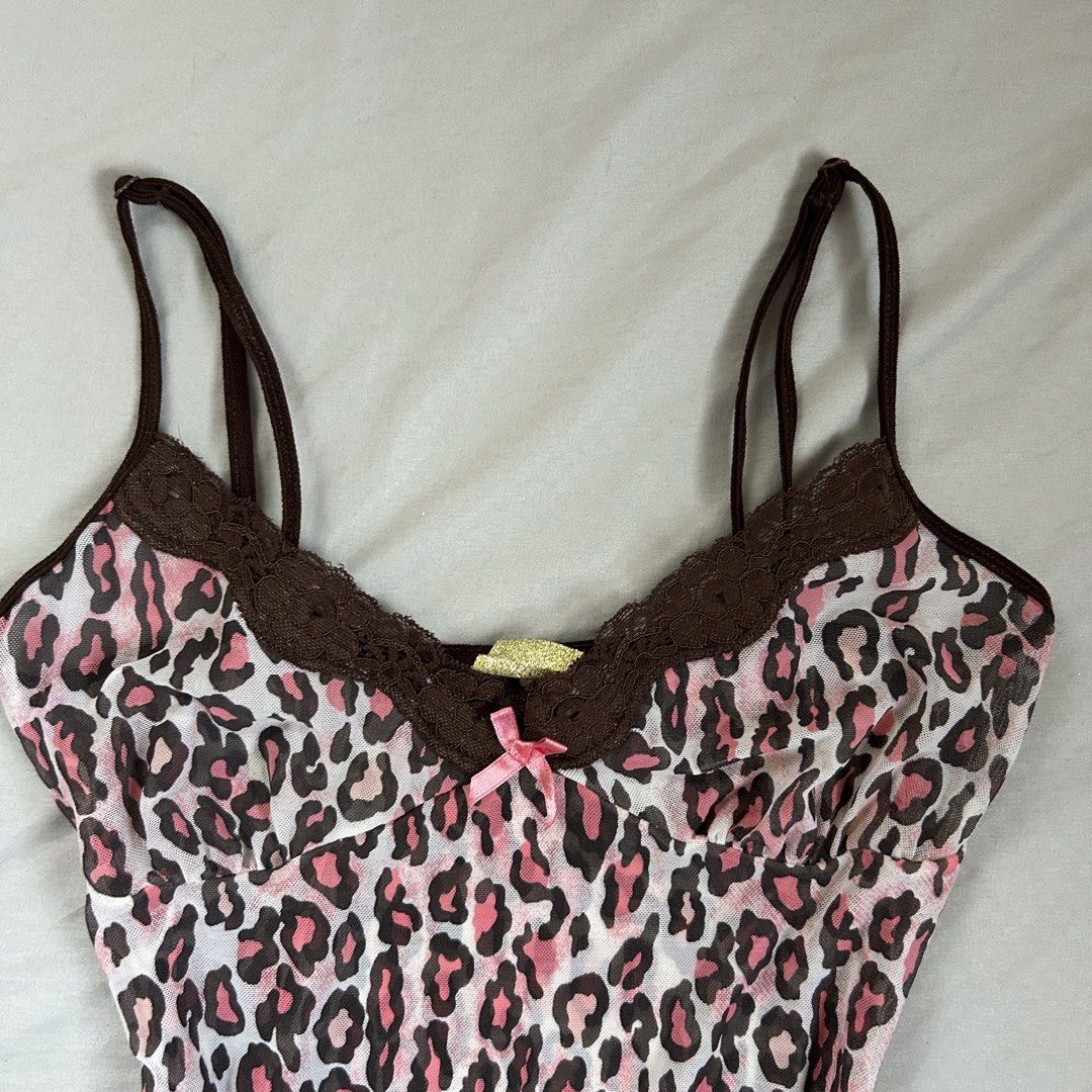 Accessorize Pink Leopard Lace Trim Cami Top (Category: Sleeveless) located in Davao. Submitted by read_my_abouts (Listing ID 1458532845, Image 2). Description: - Adorable pink leopard print camisole - Features delicate brown lace trim on neckline and hem - Sweet small pink bow accent at the front - Adjustable spaghetti straps for a perfect fit - Made from lightweight and flowy material - Versatile for layering or wearing solo.