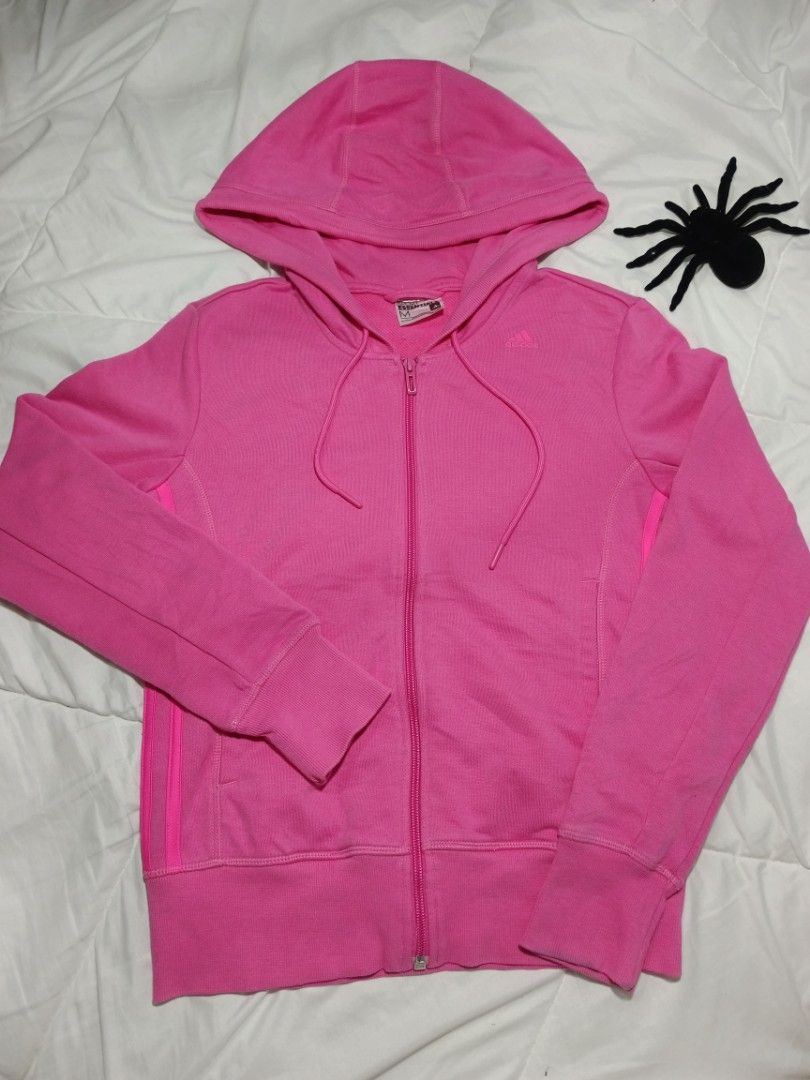 Adidas hoodie (Category: Coats, Jackets and Outerwear) located in Mendez-Nunez. Submitted by clarisucks (Listing ID 1458620560, Image 1). Description: The item in the image is a women's adidas hot pink full-zip hoodie. It features the brand's classic sporty elements, including drawstring adjustments at the hood, comfortable ribbed cuffs and hem, and iconic vertical 3-Stripes running down the sides. 17x22.