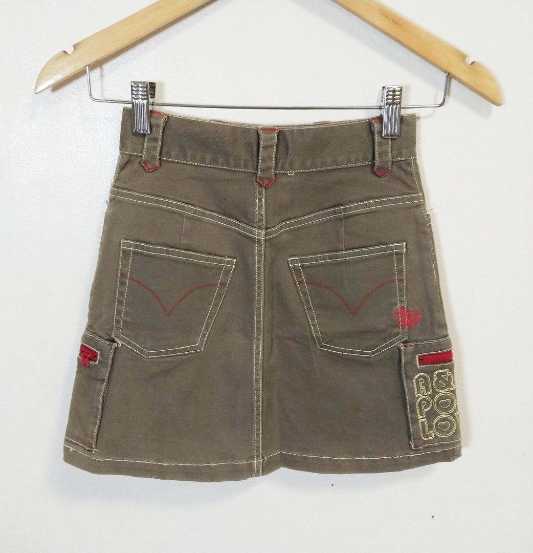 Angel Blue Cargo Skirt - Size S (Category: Skirts) located in Pateros City. Submitted by blashjunks.y2k (Listing ID 1458545273, Image 2). Description: - Cute Angel Blue cargo skirt - Khaki-brown color - Fun embroidery details - Red zipper accents - Angel Blue logo patch included - Size: S - Ideal for a casual and stylish look.