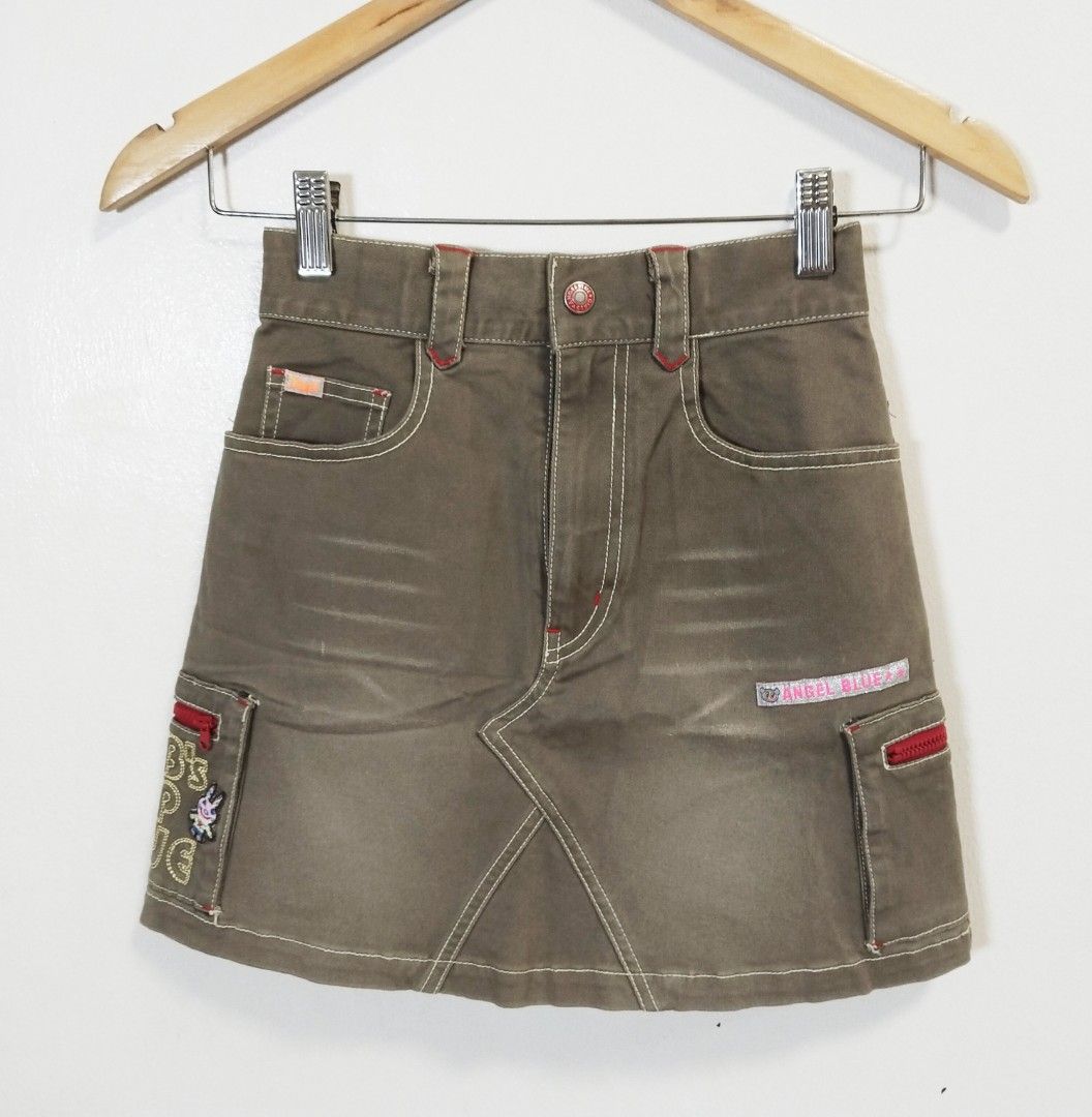 Angel Blue Cargo Skirt - Size S (Category: Skirts) located in Pateros City. Submitted by blashjunks.y2k (Listing ID 1458545273, Image 1). Description: - Cute Angel Blue cargo skirt - Khaki-brown color - Fun embroidery details - Red zipper accents - Angel Blue logo patch included - Size: S - Ideal for a casual and stylish look.