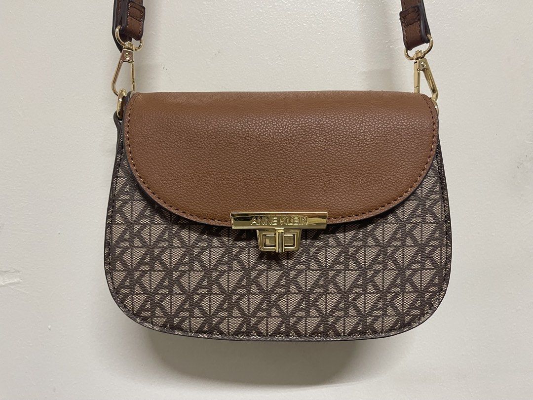 Anne Klein Saddle Flap Crossbody Bag (Category: Cross-body Bags) located in San Juan City. Submitted by marthina.jacobo (Listing ID 1458688949, Image 2). Description: Brown monogram saddle crossbody bag with a tan textured flap and gold-tone turn-lock hardware Used 3 times Issue: Handles removed due there is damage upon purchase (sale) but still serve its purpose as crossbody bag (pls see photo) Not noticeable RFS: Decluttering Actual color may s