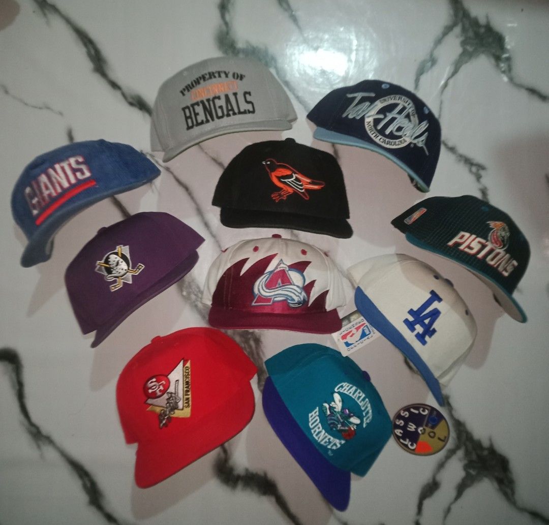 Assorted Baseball Caps - Various Teams & Brands (Category: Caps & Hats) located in Manila. Submitted by ramosjacqu35241 (Listing ID 1458556651, Image 2). Description: For sale ‼️ Vintage hats 🔥 Giants dline cords by Sport Specialties - 1850 Bengals Property by NE pro model - 1800 Tar Heels UNC by the game - 1300 Mighty ducks OG logo by Anco - 1300 Oreoles OG logo by SS sz 7 1/8 - 3500 Pistons by logo athletics - 1300 Avalanche Stooth by Logo 7 -
