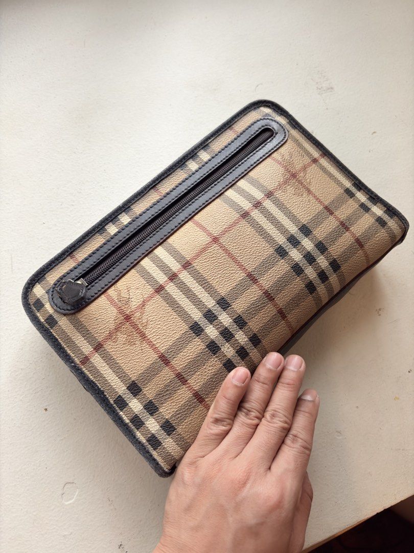 Authentic Burberry Nova Check Clutch Bag (Category: Luxury Bags & Wallets) located in Mandaluyong City. Submitted by wear_your_style (Listing ID 1458554383, Image 2). Description: Made in Italy. Bought preloved in Japan. This is vintage hence the engraved playe says Burberrys. PVC material with leather and fabric details. So super sturdy neto. Inside is nylon. 3 zipped compartments all in all. Dimensions: approx 7.3 inches long and 10.75 inches w