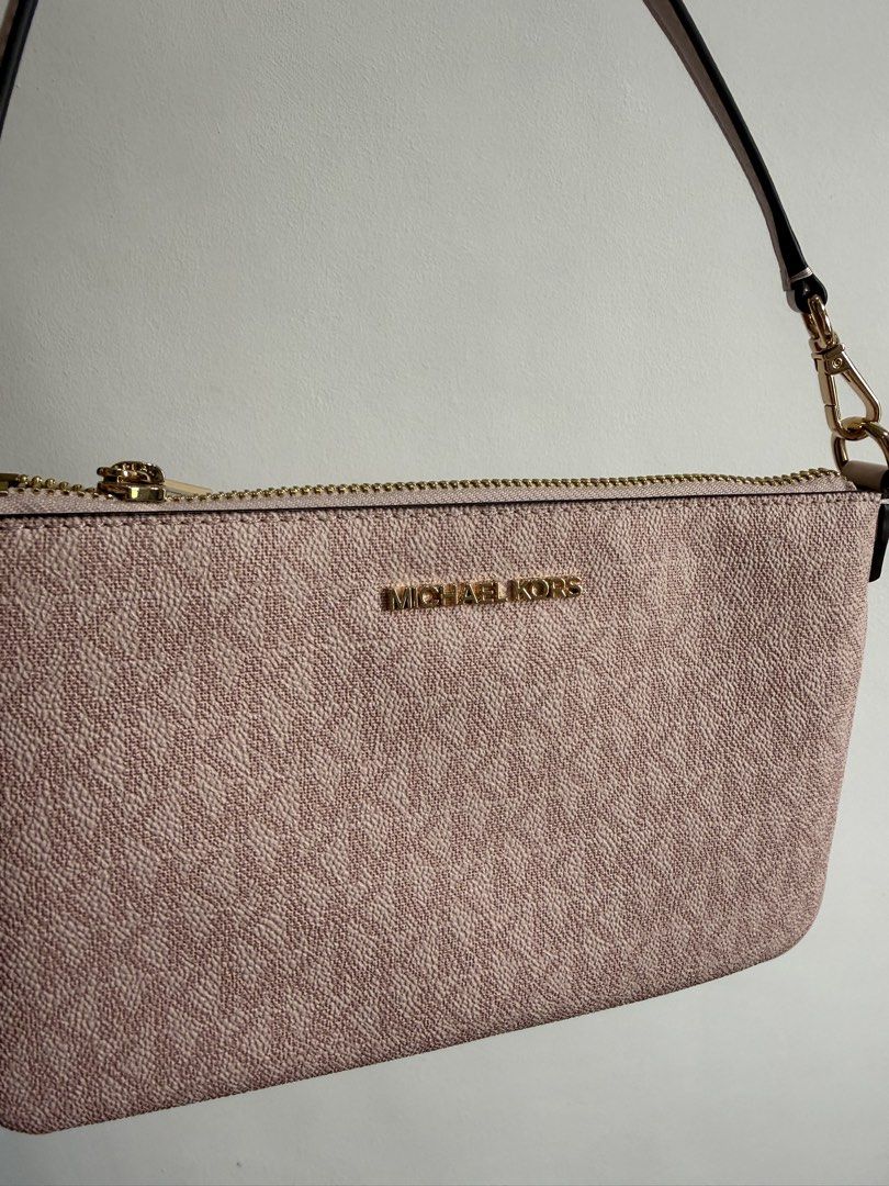 Authentic Michael Kors Pink Shoulder Bag (Category: Luxury Bags & Wallets) located in Batangas. Submitted by shopmystuff_ (Listing ID 1458511004, Image 2). Description: - Cute pink Michael Kors wristlet - All-over MK monogram pattern - Secure gold zipper closure - Detachable strap with gold clip - Small and compact, ideal for carrying essentials.