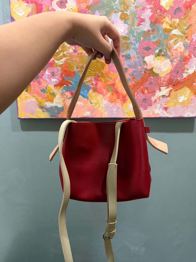 Aztrid Lulu Bag (Category: Cross-body Bags) located in Manila. Submitted by joshtoleds (Listing ID 1458555291, Image 2). Description: - Cute red leather bucket bag - Secure drawstring closure - Versatile carrying options: long adjustable strap and shorter top handles - Convenient interior slip pockets - Ideal for everyday use - Chic minimalist design Super mint condition. Price is negotiable Loc: Bacoor, Cavite/Manila.