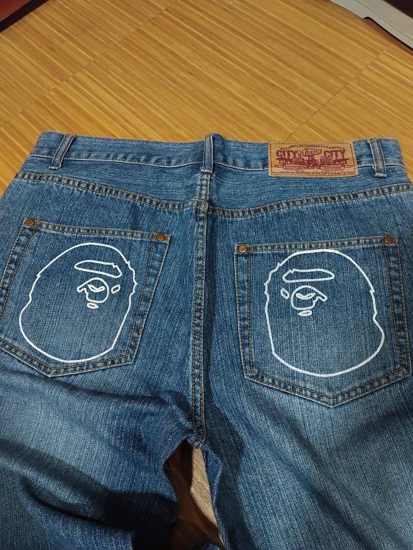 BAPE A Bathing Ape Denim Jeans Ape Head Logo (Category: Jeans) located in Manila. Submitted by unghettoboysclub (Listing ID 1458622249, Image 3). Description: - Brand: BAPE -Dimensions: W:37 L:45.5 T:13.5 H:9 - Type: Blue Denim Jeans - Size: Tagged XL - Features: Iconic Ape Head logo embroidered on back pockets - Fit: Classic straight leg - Style: Ideal for streetwear collections.
