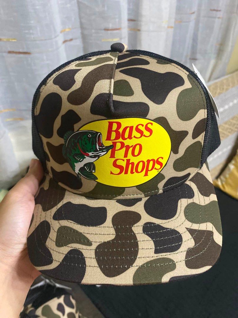 Bass Pro Shops Camo Mesh Trucker Cap OSFM (Category: Caps & Hats) located in Pasig City. Submitted by rieperez (Listing ID 1458504569, Image 1). Description: - Bass Pro Shops trucker cap - Features classic logo and camouflage pattern - Mesh back for enhanced breathability - One size fits most design - Ideal for outdoor adventures or everyday casual style.