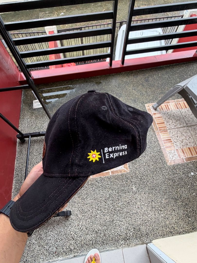 Bernina Express Black Baseball Cap (Category: Caps & Hats) located in Manila. Submitted by transbox (Listing ID 1458546645, Image 2). Description: - Black baseball cap with oval patch on front - Embroidered 'Bernina Express' logo on the side - Adjustable strap at the back for a custom fit - Made from durable material - Ideal for casual wear and outdoor activities - Show your Bernina Express pride! - Not thrifted.