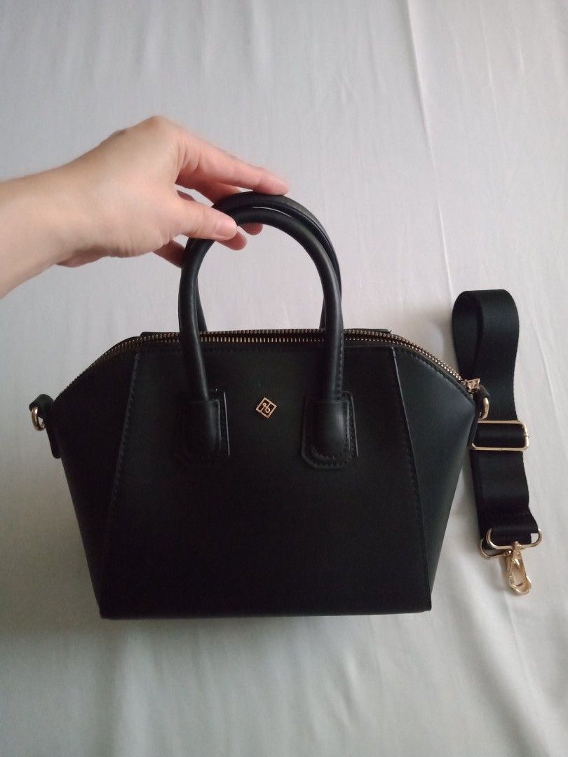 Black Call It Spring Dome Handbag with Detachable Strap (Category: Luxury Bags & Wallets) located in Dagupan City. Submitted by iam_clutterfree (Listing ID 1458555356, Image 1). Description: - Classic black dome handbag - Secure zip closure - Subtle gold logo detail on the front - Detachable black strap with gold hardware - Interior zip pocket - Interior slip pocket - Versatile for everyday use or dressing up an outfit. Dimensions: LxWxH (11x4x11