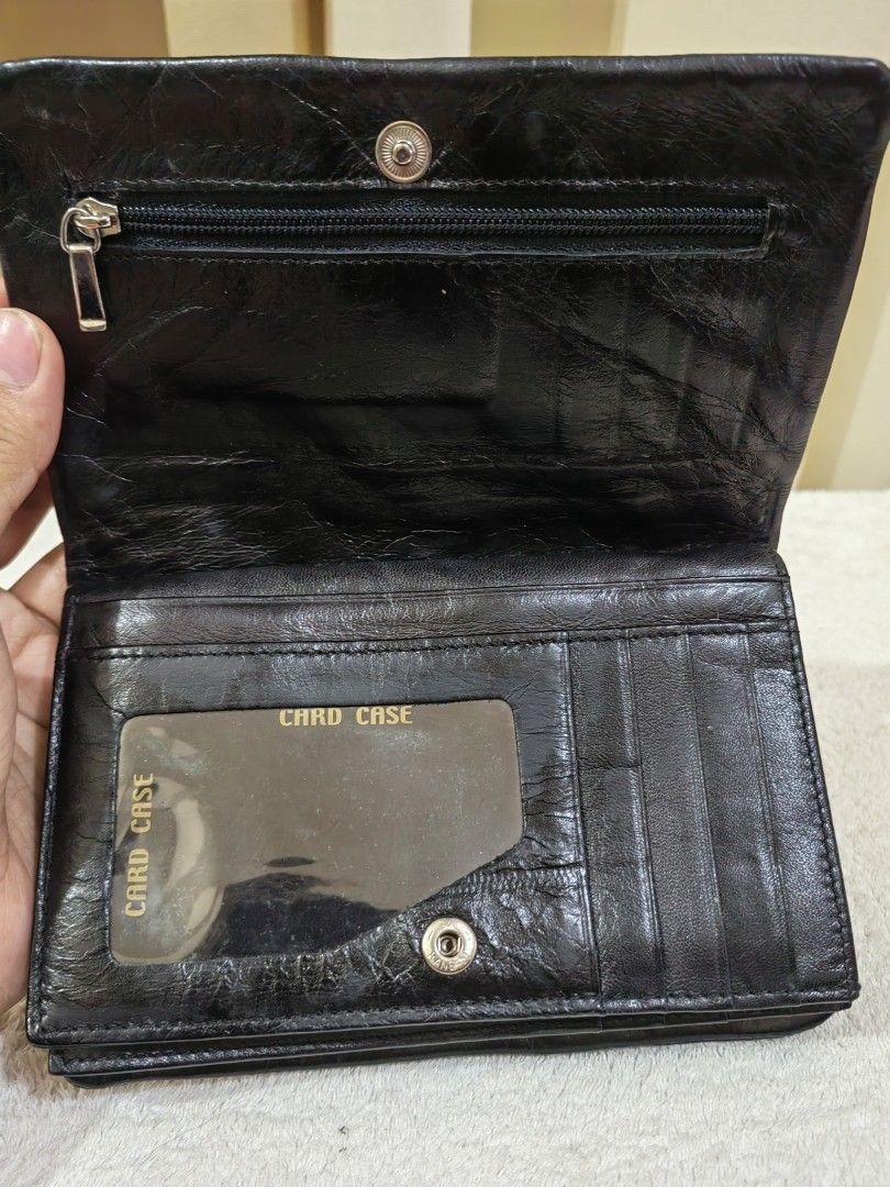 Black Leather Wallet with Multiple Compartments (Category: Wallets & Card holders) located in Makati City. Submitted by prelovedtreatedwithlove (Listing ID 1458589630, Image 2). Description: - Black leather wallet - Zip pocket inside - Multiple card slots - Clear ID window - Secure snap closure - Functional, unique wallet - quadfold,. Medium size -Genuine leather - No issue like new.