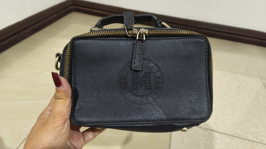 Metro Bag Black Mini Handbag with Embossed Logo (Category: Luxury Bags & Wallets) located in Caloocan City. Submitted by majehjembo8 (Listing ID 1458626735, Image 1). Description: - Cute black mini handbag - Zip closure - Top handle - Embossed logo on front - Detachable strap included - Ideal for carrying essentials.