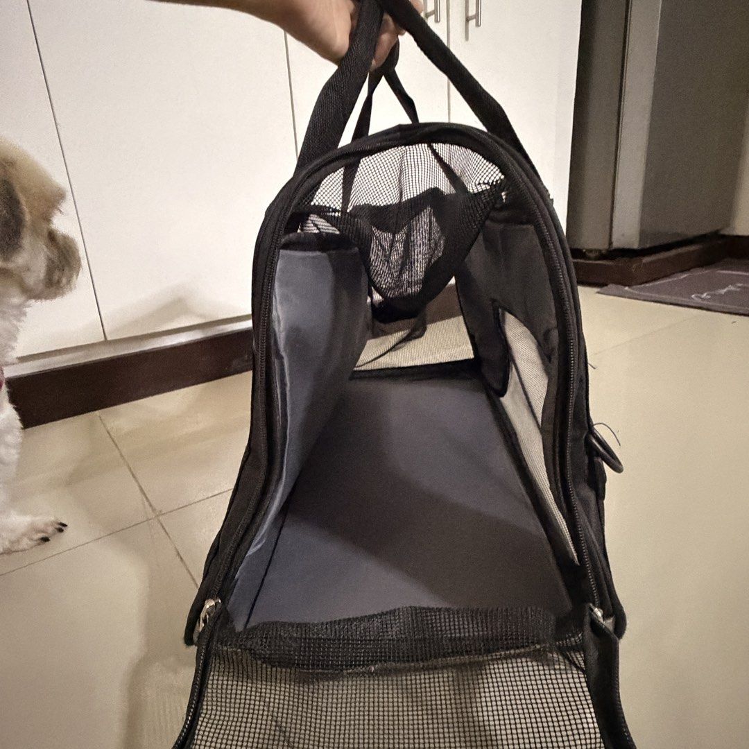 Black Pet Carrier Bag with Mesh Panels (Category: Homes & Other Pet Accessories) located in Marikina City. Submitted by _bananahanaa (Listing ID 1458552795, Image 2). Description: - Durable black pet carrier bag - Mesh panels on sides and front for ventilation - Includes a removable base pad - Top and side zippers - Front zippered pocket.