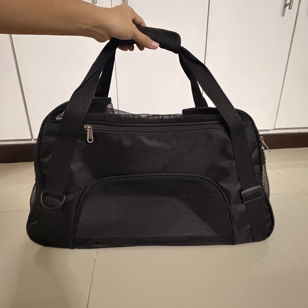 Black Pet Carrier Bag with Mesh Panels (Category: Homes & Other Pet Accessories) located in Marikina City. Submitted by _bananahanaa (Listing ID 1458552795, Image 1). Description: - Durable black pet carrier bag - Mesh panels on sides and front for ventilation - Includes a removable base pad - Top and side zippers - Front zippered pocket.