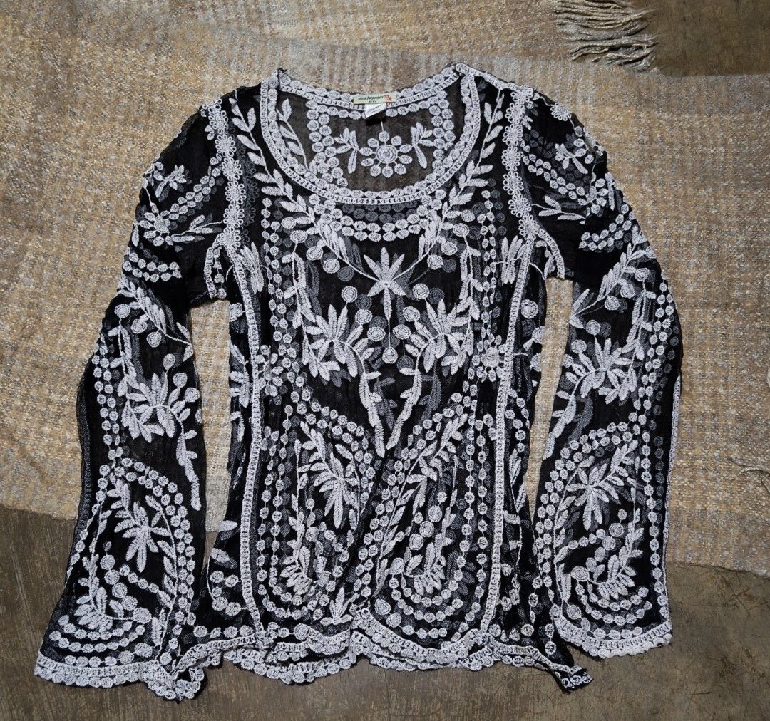 Black sheer embroidered bell sleeve blouse (Category: Blouses) located in La Paz. Submitted by carou89146 (Listing ID 1458538983, Image 2). Description: Vivid Importers of New York - Sheer black fabric - Intricate white embroidery details - Long, flowy bell sleeves with embroidered cuffs - Embroidered neckline and hem - Lightweight and airy design,see thru - Versatile for layering or as a standalone statement piece small on tags but can fit to me