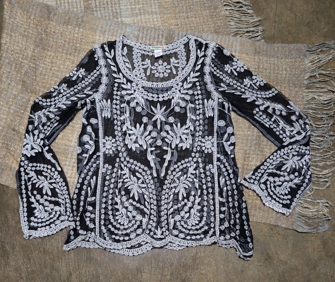 Black sheer embroidered bell sleeve blouse (Category: Blouses) located in La Paz. Submitted by carou89146 (Listing ID 1458538983, Image 1). Description: Vivid Importers of New York - Sheer black fabric - Intricate white embroidery details - Long, flowy bell sleeves with embroidered cuffs - Embroidered neckline and hem - Lightweight and airy design,see thru - Versatile for layering or as a standalone statement piece small on tags but can fit to me