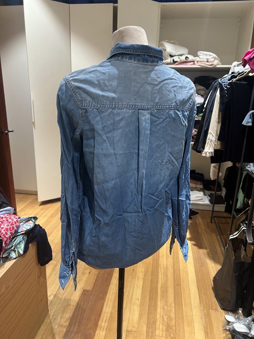 Blue Denim Long Sleeve Shirt (Category: Longsleeves) located in Quezon City. Submitted by iminquezoncity (Listing ID 1458518356, Image 2). Description: - Classic blue denim shirt - Long sleeves with button cuffs - Two chest pockets with button closures - Button-up front - Versatile for layering or wearing on its own.