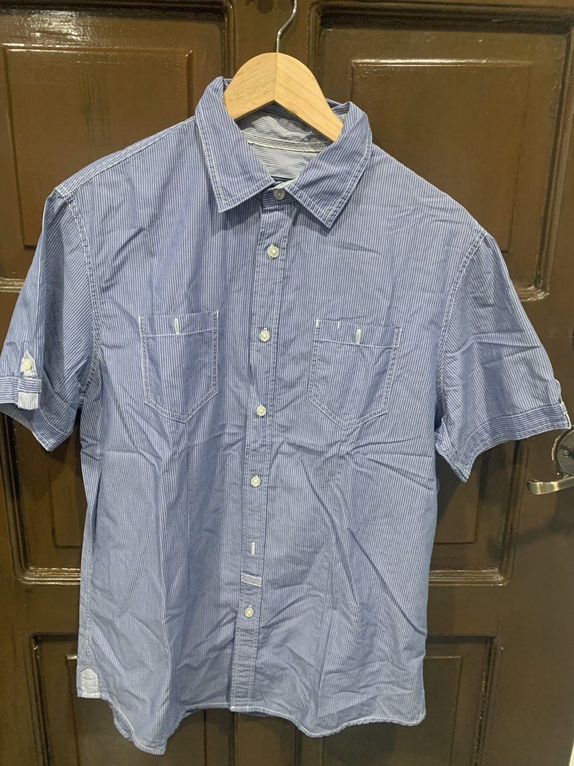Blue Striped Short Sleeve Button Up Shirt (Category: Shirts) located in Paranaque City. Submitted by rizatamayo (Listing ID 1458527014, Image 3). Description: - Classic blue and white pinstripe short sleeve shirt - Features two chest pockets with button closures - Full button-up front - Measurements: Pit to pit approx. 21 inches, Length approx. 29 inches - Perfect for casual outings and everyday wear.